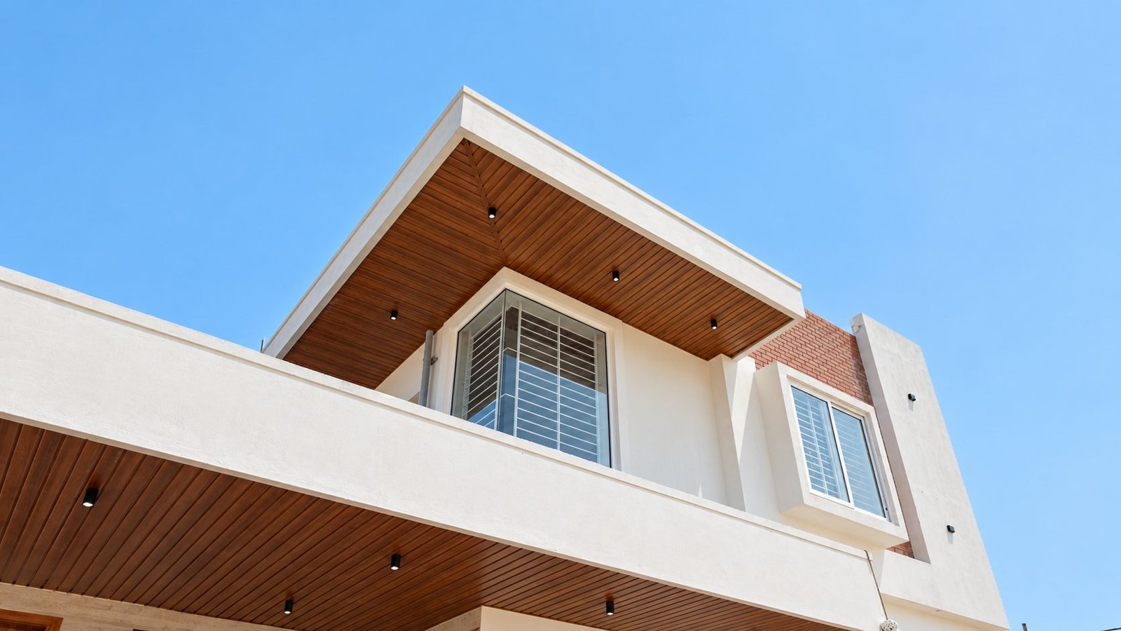 Terra Bliss villa built by Builders Pollachi: wood-finish canopy against a blue sky