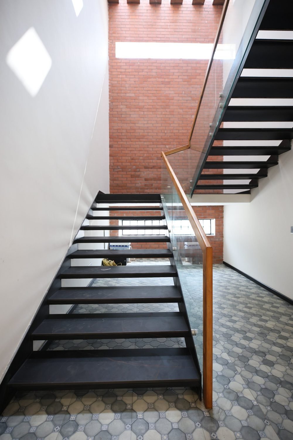 Staircase with brick wall